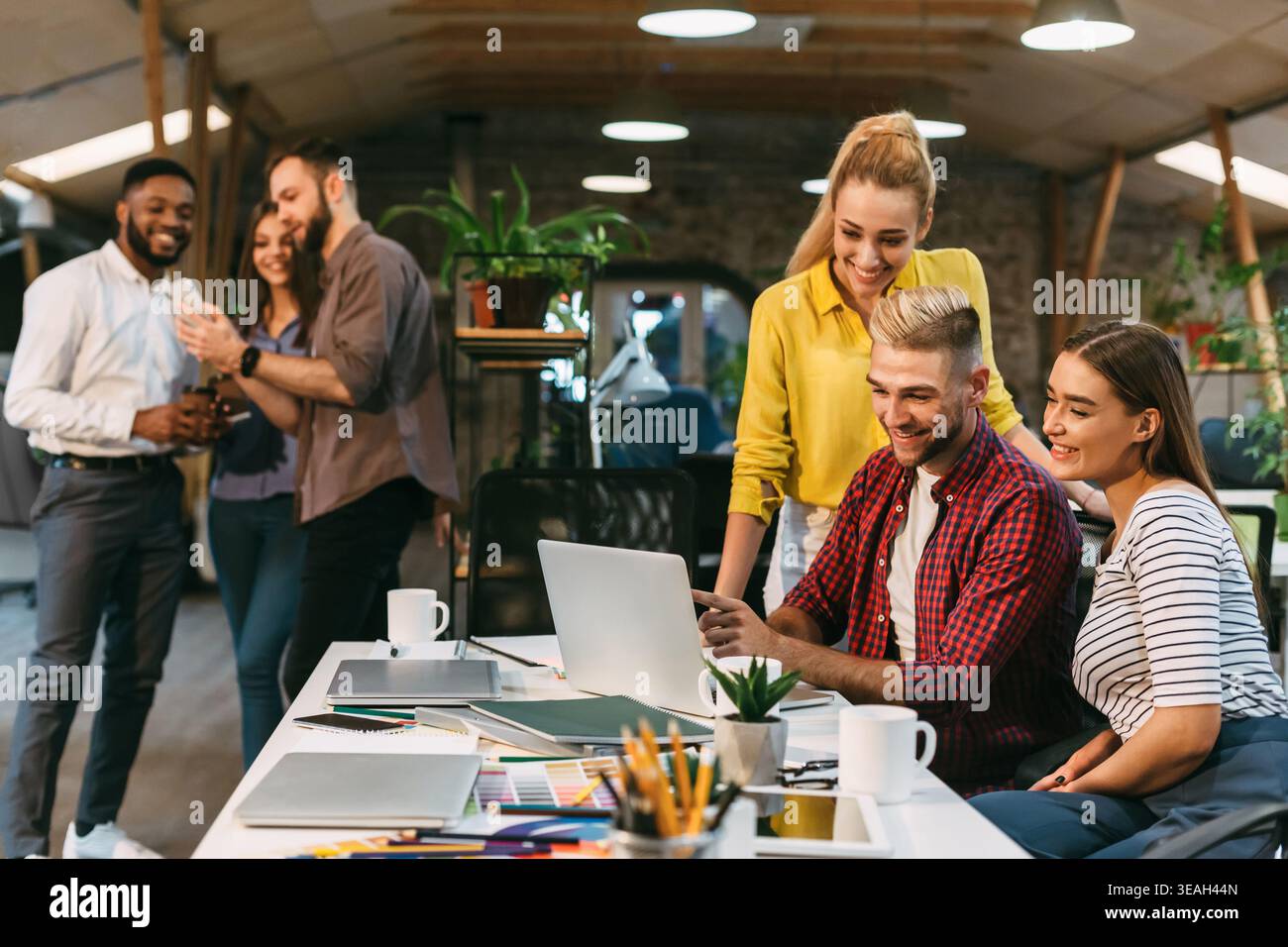 Group Collaboration in Modern Workspace Focused on Creative Project Stock Photo