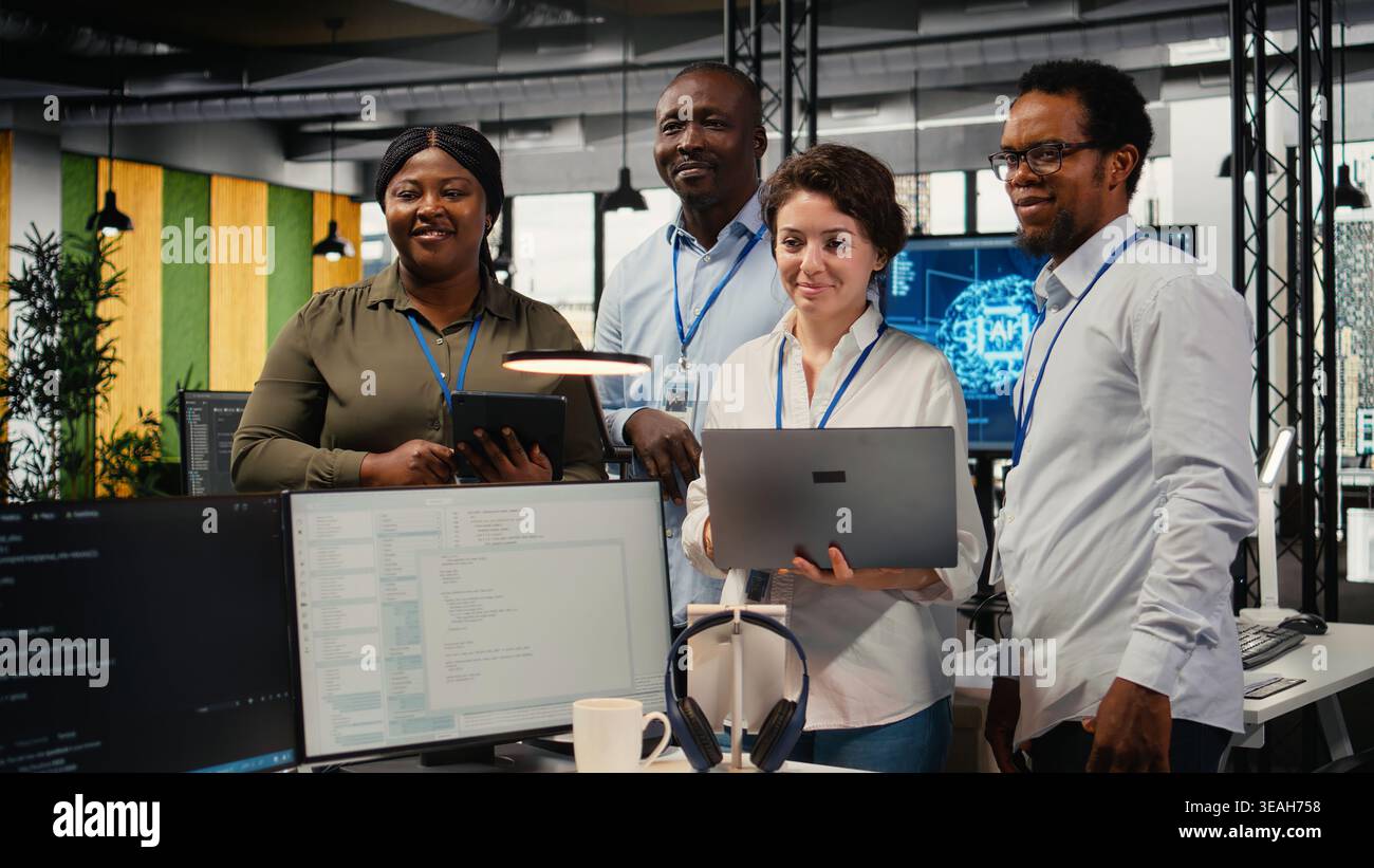 Portrait of smiling engineering team in office automating workflows using artificial intelligence tech. Happy coworkers refining deep learning computational models for faster processing, camera A Stock Photo