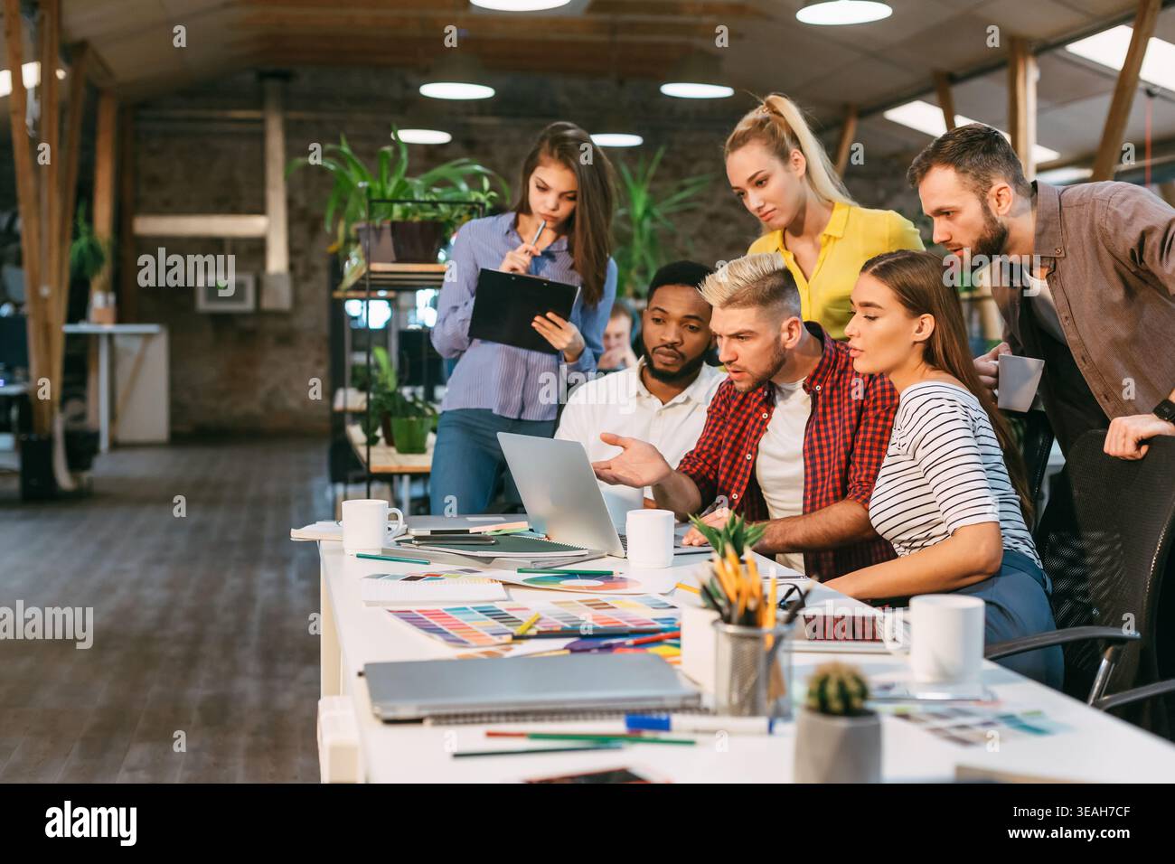 Startup concept. Young colleagues working on new project Stock Photo