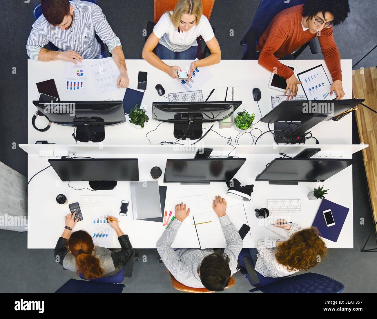 Team Collaborates on Project in Modern Office During Working Hours Stock Photo