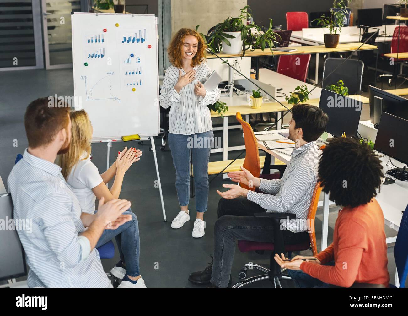 Woman team leader making presentation for colleagues Stock Photo