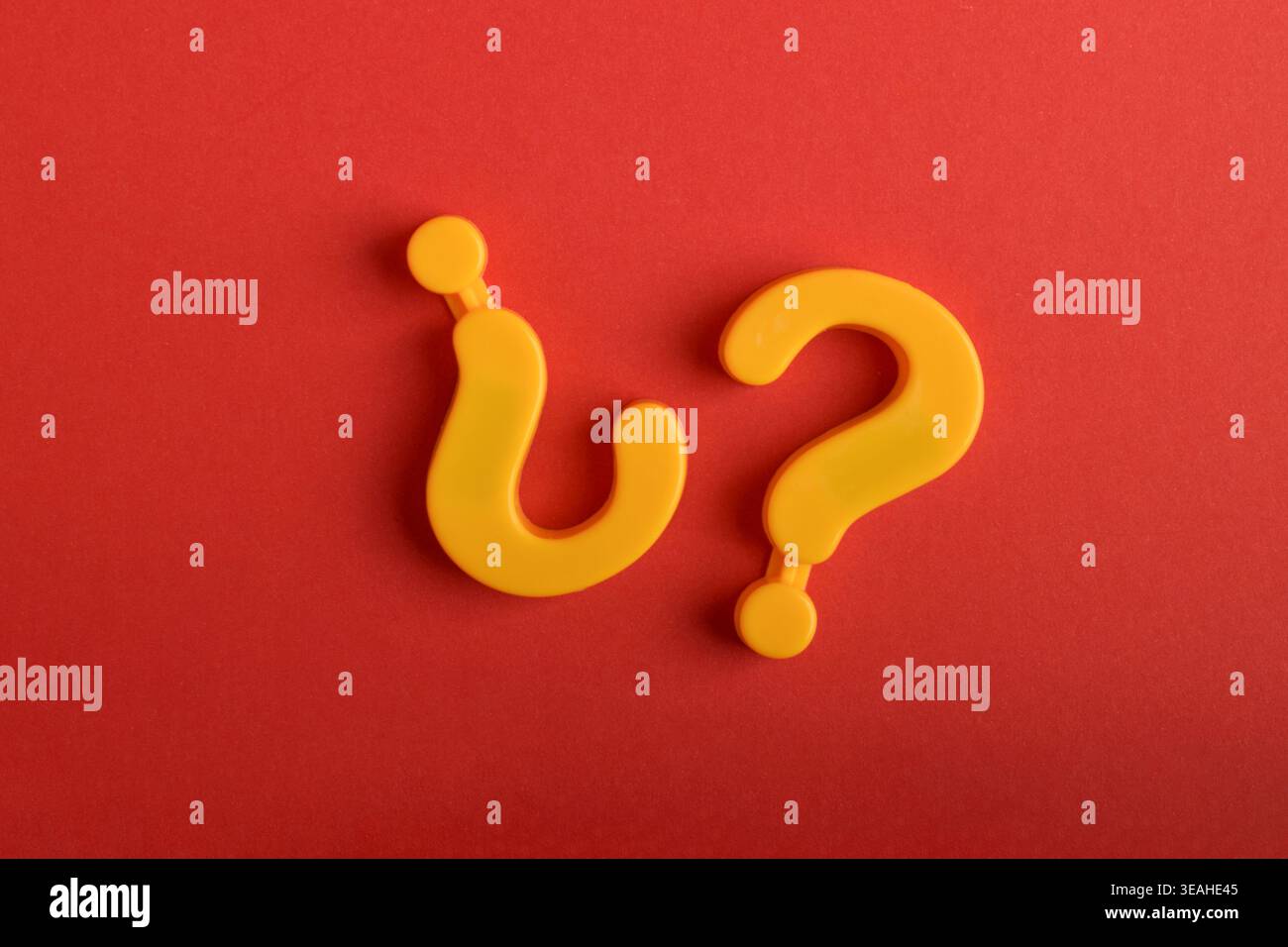 Question and inverted question mark on red background, symbolizing ...