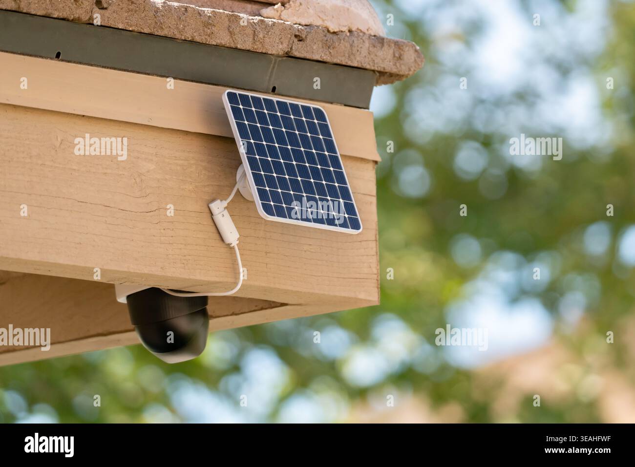 Solar powered security camera mounted on house exterior Stock Photo