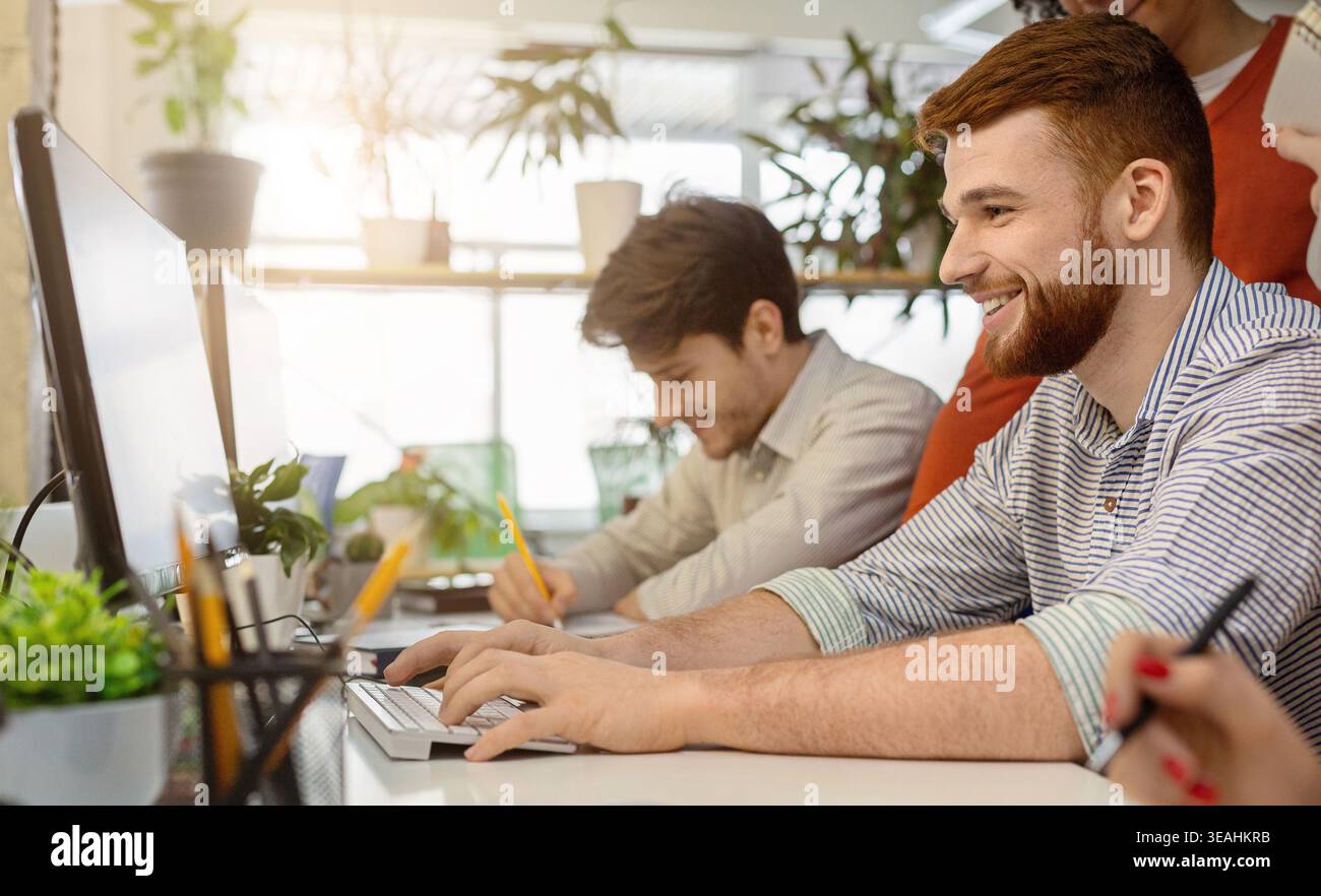 System administrator working on computer in office Stock Photo