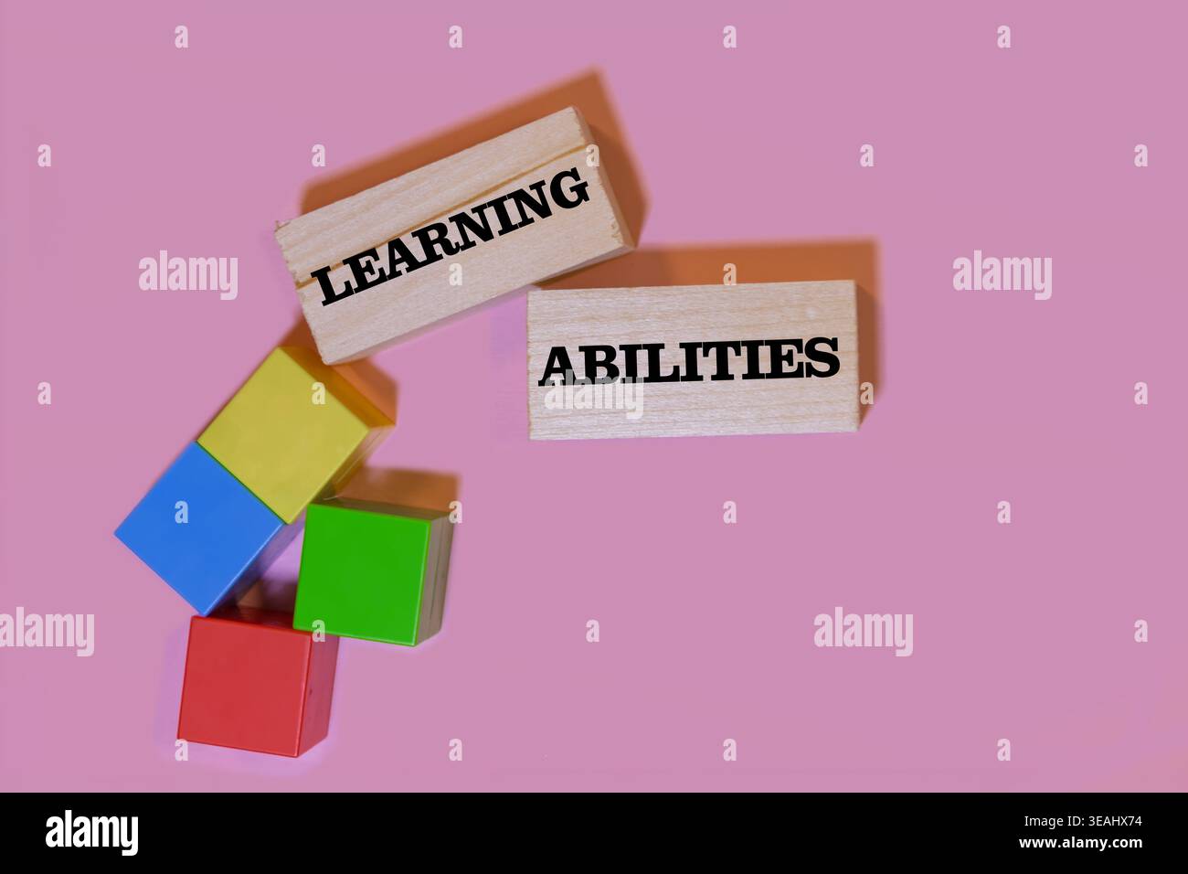 Wooden blocks with Learning Abilities text on pink background Stock Photo