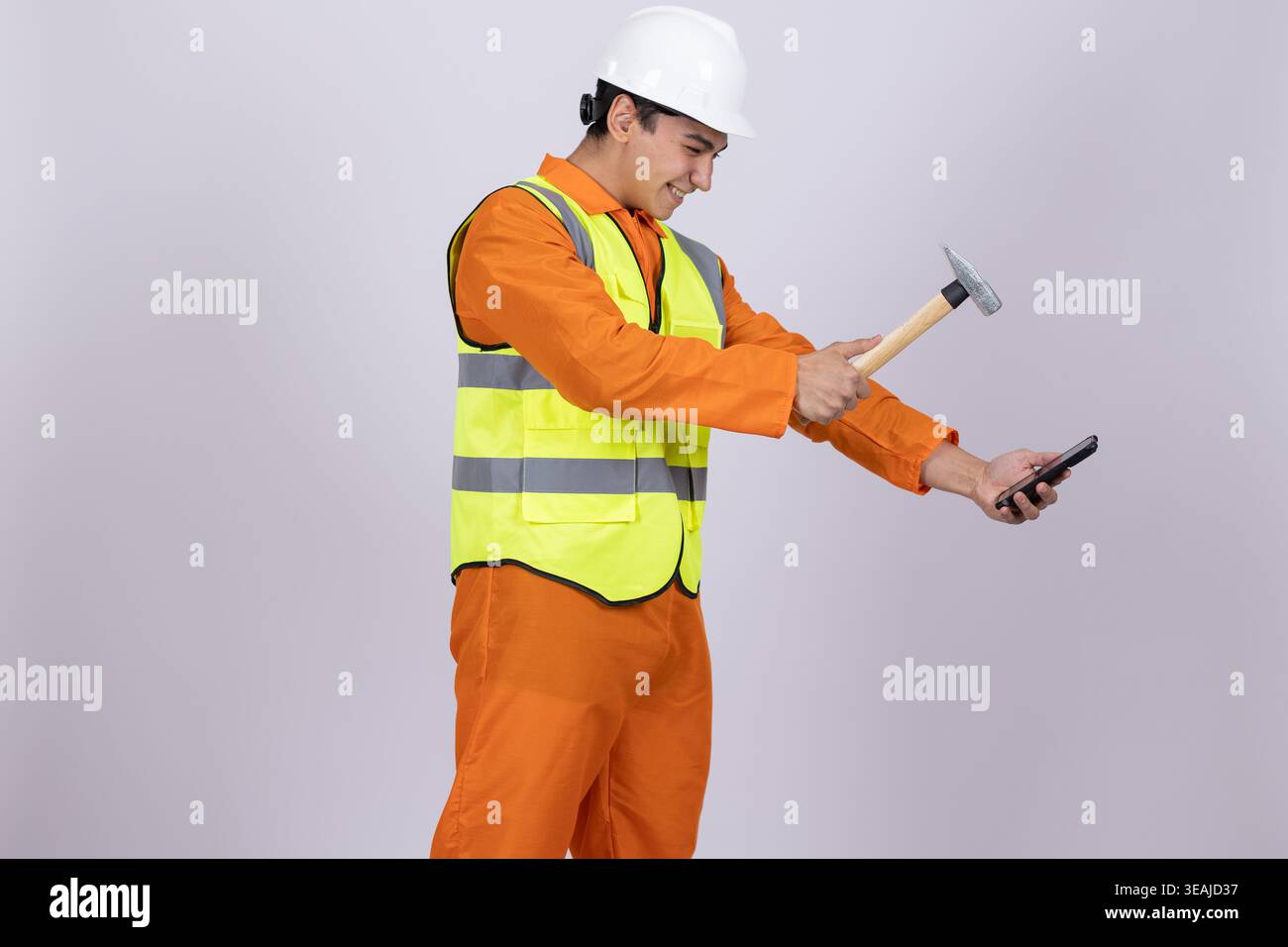 Construction worker in safety vest holding a hammer Stock Photo