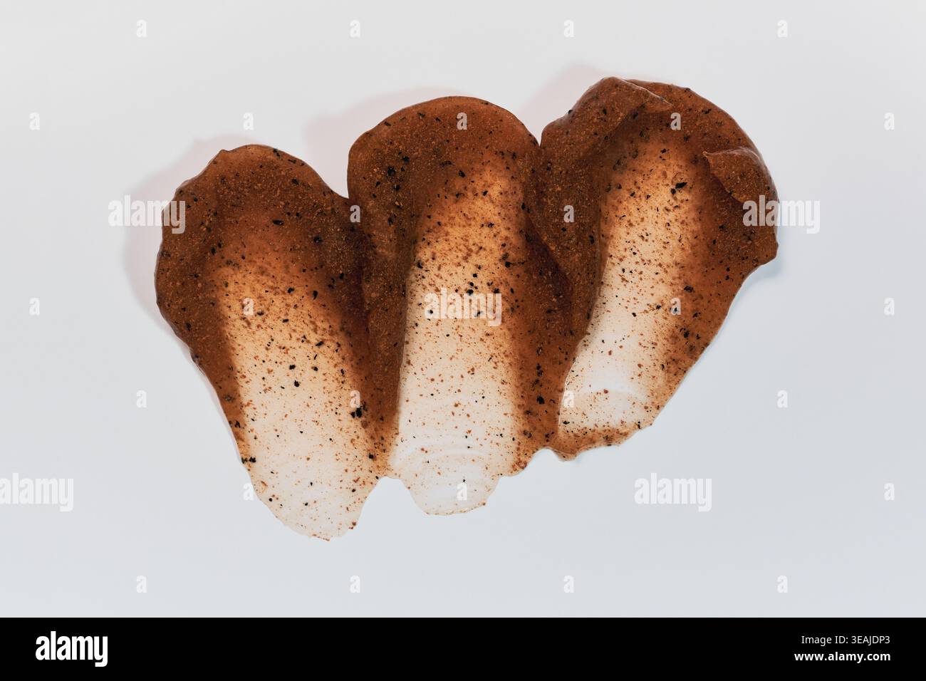 Coffee scrub smears creating textural swatch on white background Stock Photo