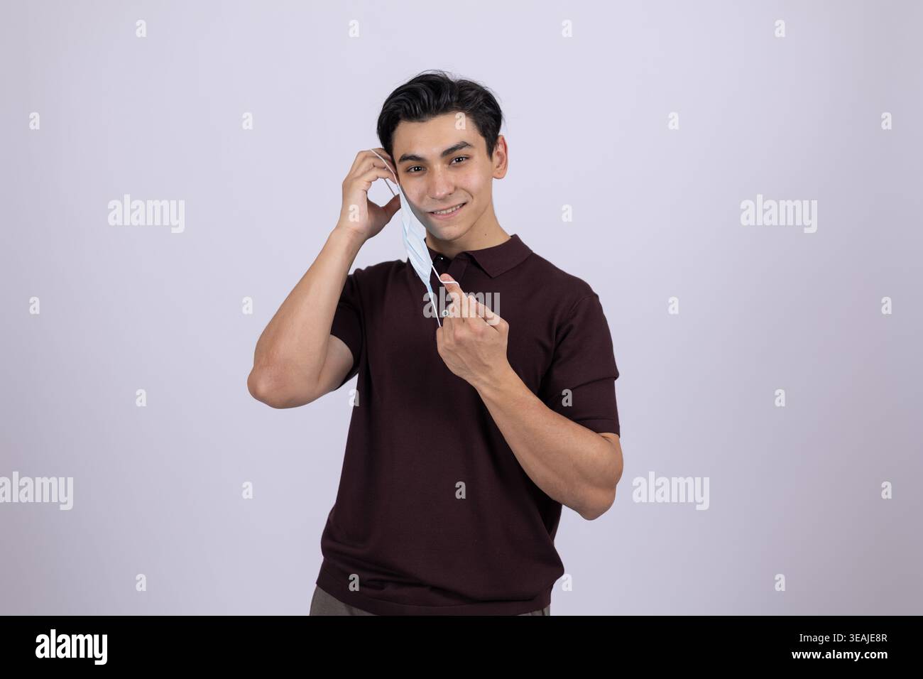 Young man pointing at camera with finger and smiling Stock Photo