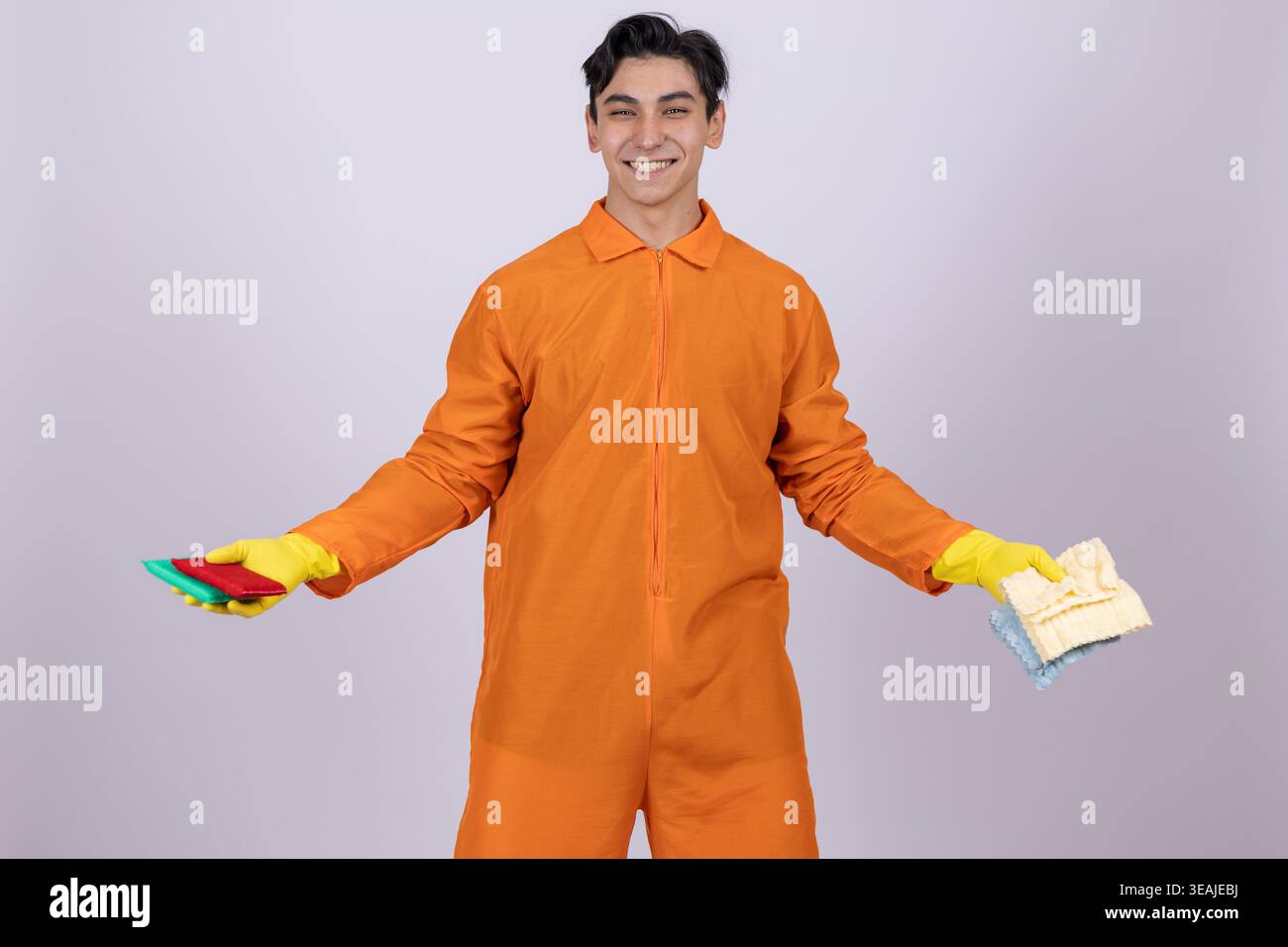 Worker in orange coveralls gesturing with hands Stock Photo