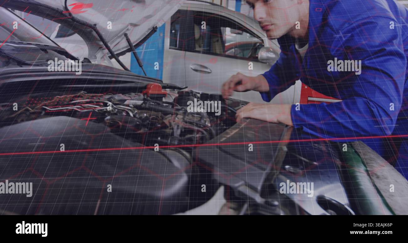Inspecting mechanic in blue coverall leaning over open hood in garage checking wiring, copy space Stock Photo
