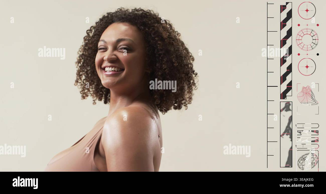 Smiling woman posing three-quarter on beige backdrop, in beige sleeveless top, showing right panel Stock Photo