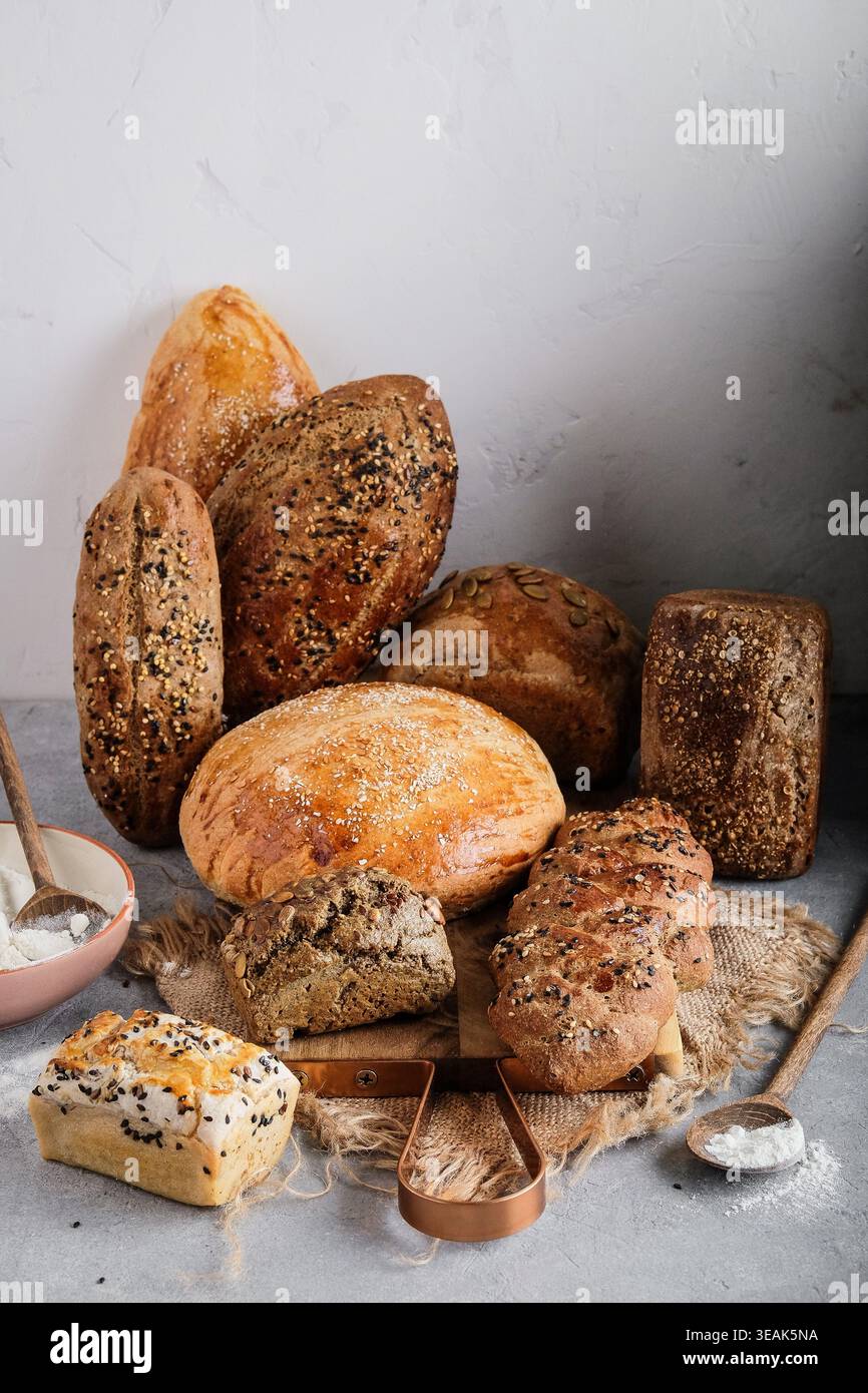 Artful Display Of Bread And Accompaniments. Rustic Bread Slices Arranged With Butter And Grains Stock Photo