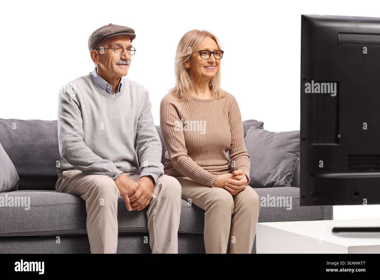 Woman sitting on gray couch hi-res stock photography and images - Alamy