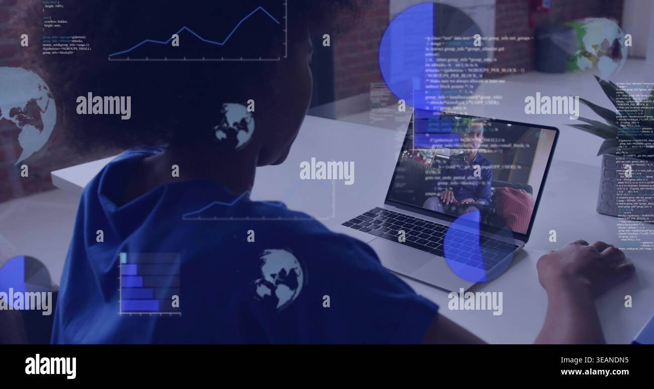 Analyzing woman in blue top reviewing code on laptop with data visualizations at white desk. Remote, collaboration, programming, developer, charts, gl Stock Photo
