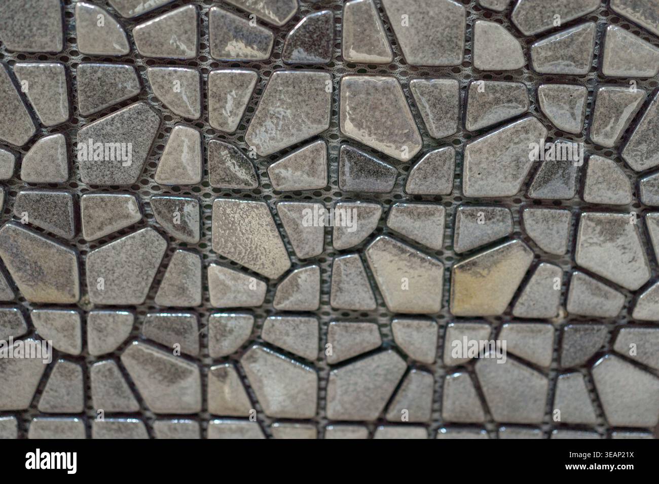 Small stone mosaic pattern forming organic texture. Natural decorative surface.  Stock Photo