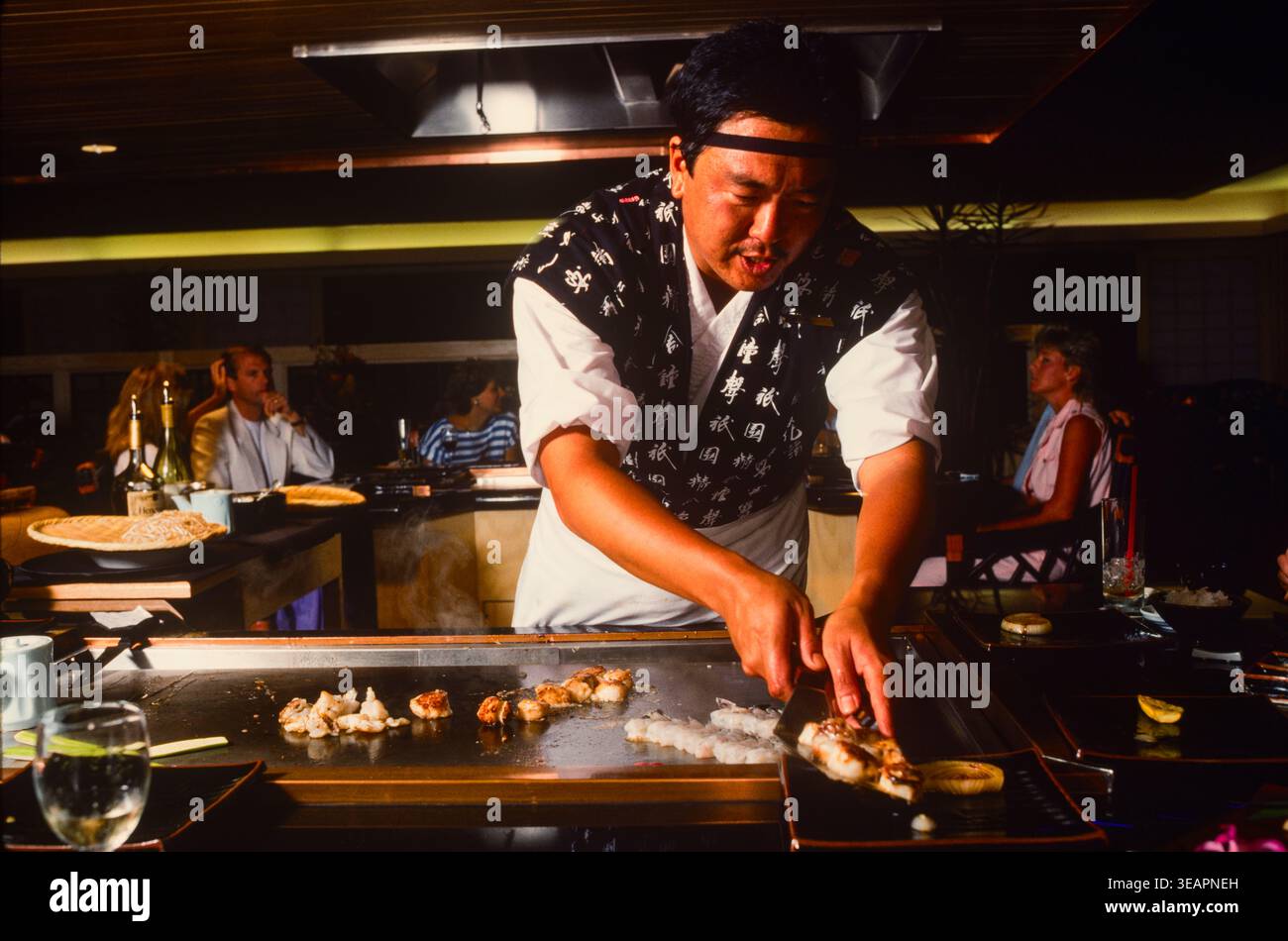 A Japanese chef cooking at one of the restaurants at an up-market hotel on Maui Island, Hawaii, USA Stock Photo