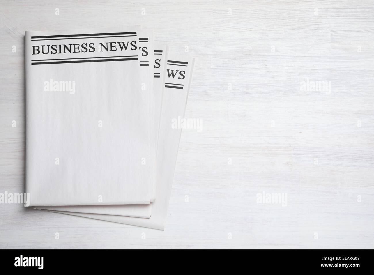 Folded newspapers on white wooden background, top view Stock Photo