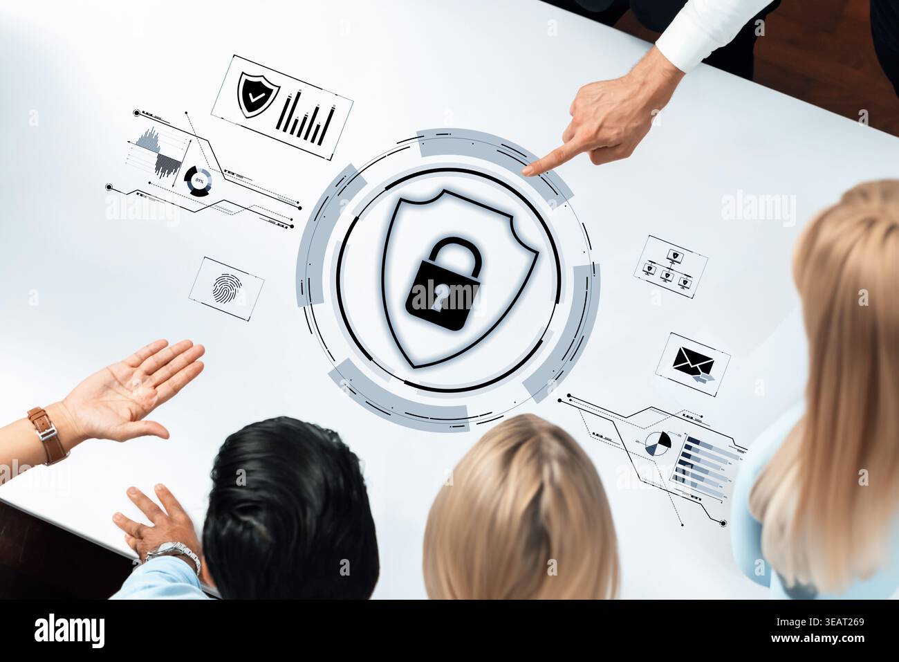 A group of professionals engages in cybersecurity discussions using an interactive table displaying security icons and data, emphasizing collaboration Stock Photo