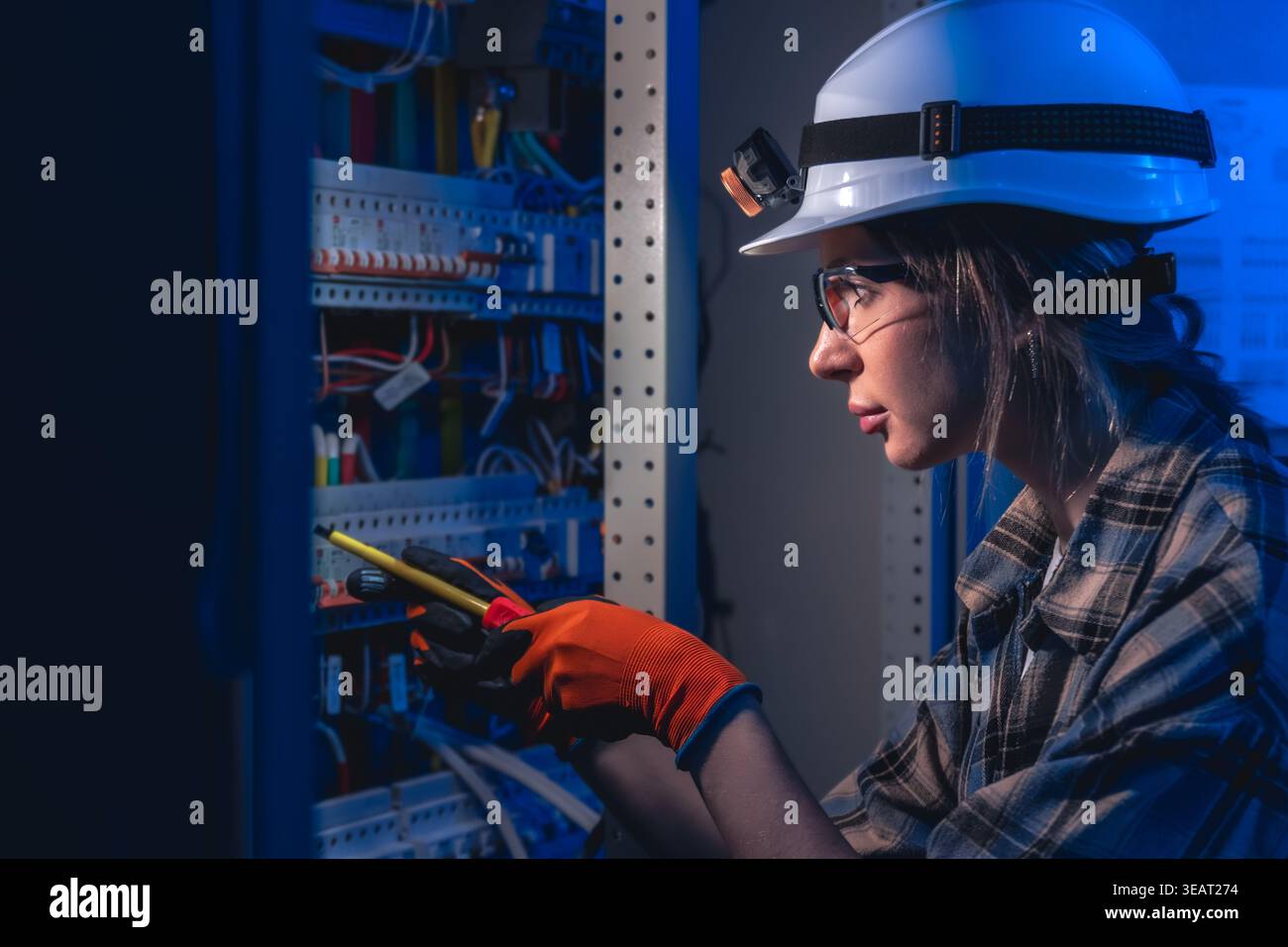 Electrician inspecting electrical system with voltage tester. Engineering inspection. Stock Photo
