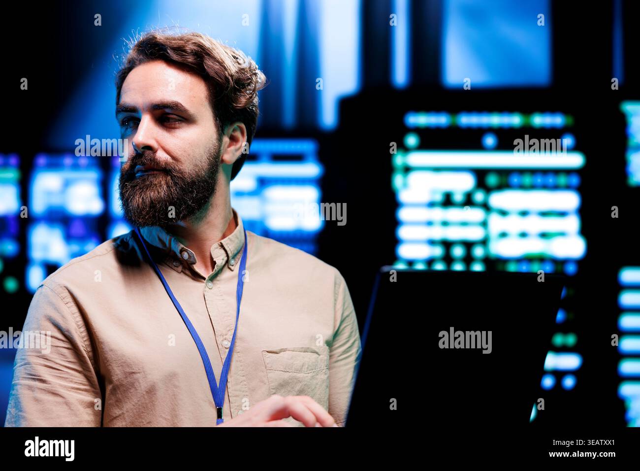IT Specialist looking at operational servers in computer network security data center. Mainframes providing processing and memory resources needed for computational operations Stock Photo