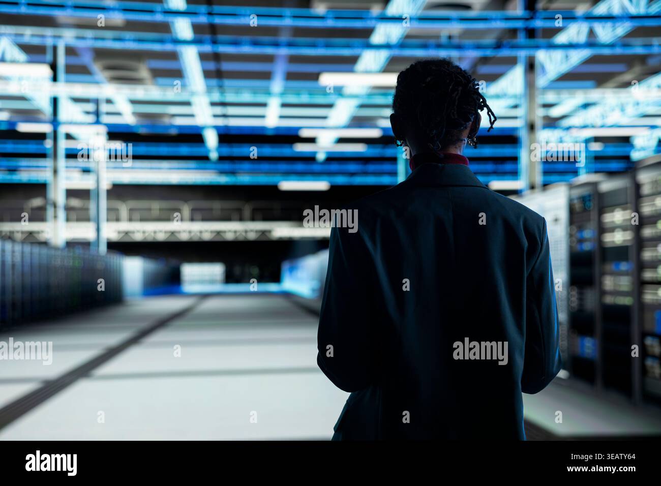 Admin walking in data center, configuring server settings with software. IT professional in modern high tech server hub doing maintenance tasks on infrastructure electronics Stock Photo