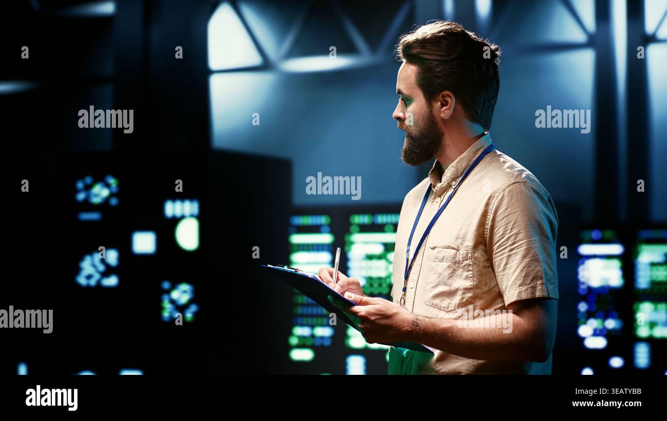 Admin walking in data center supporting AI through high performance computing, hosting specialized storage and networking hardware. Engineer ensuring server room internal hardware functions properly Stock Photo