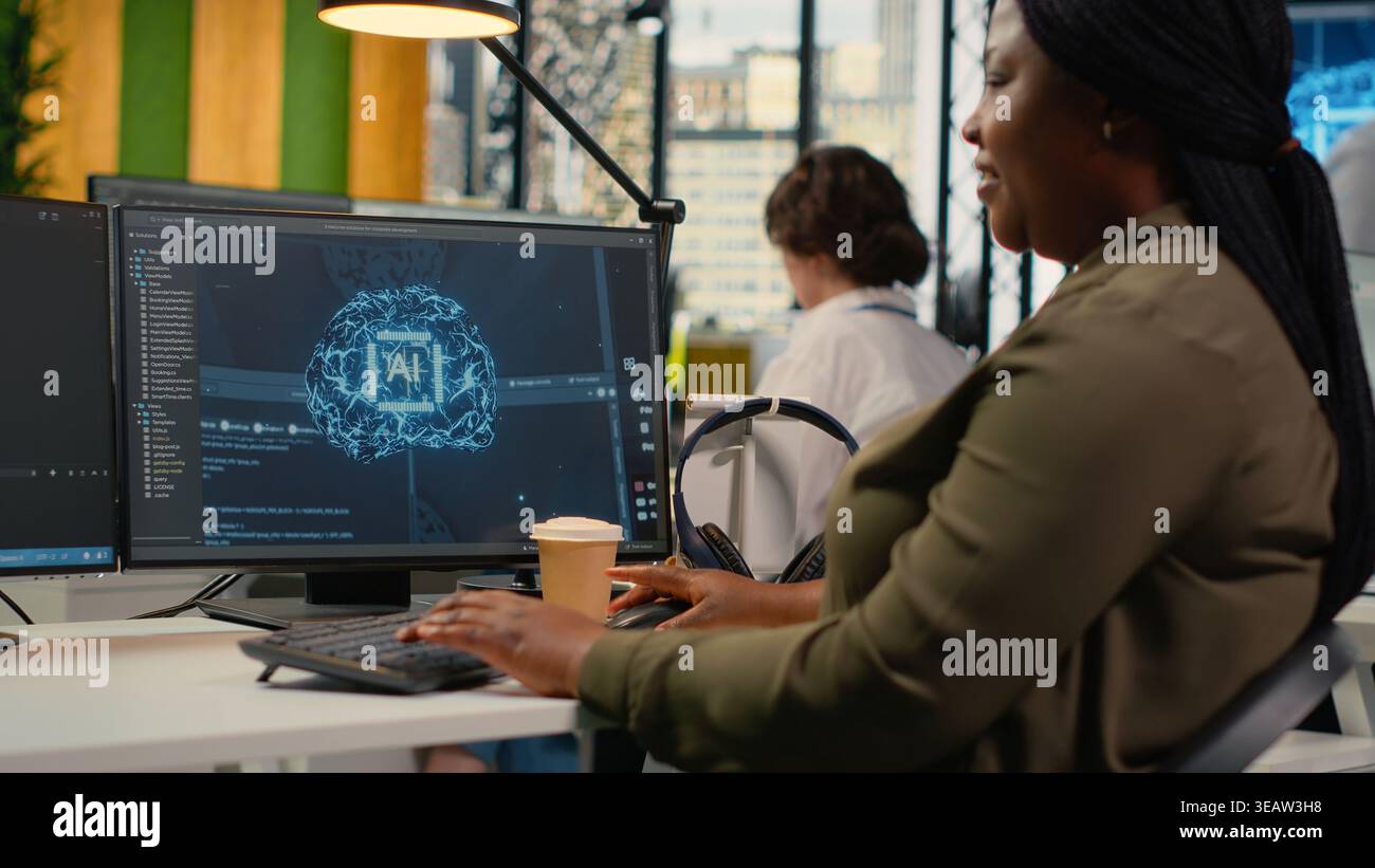 System administrators doing brainstorming in office, using specialized hardware to accelerate complex AI calculations. Engineering team managing systems for deep learning training datasets, camera B Stock Photo