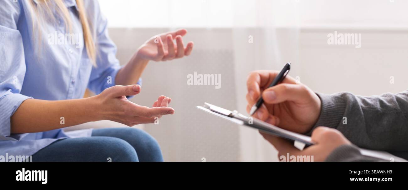 Young woman having discussion with personal therapist Stock Photo