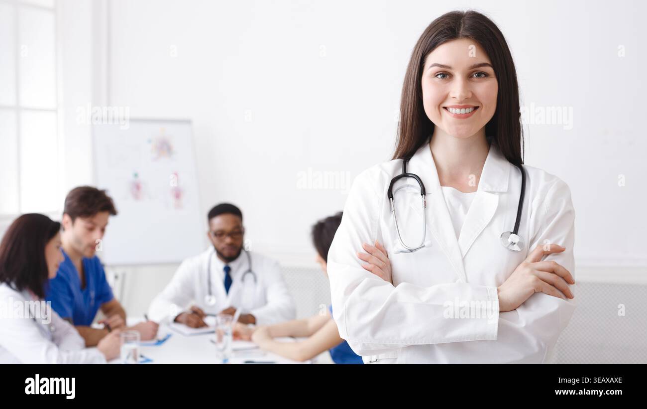 Happy Doctor With Stethoscope Posing To Camera Stock Photo