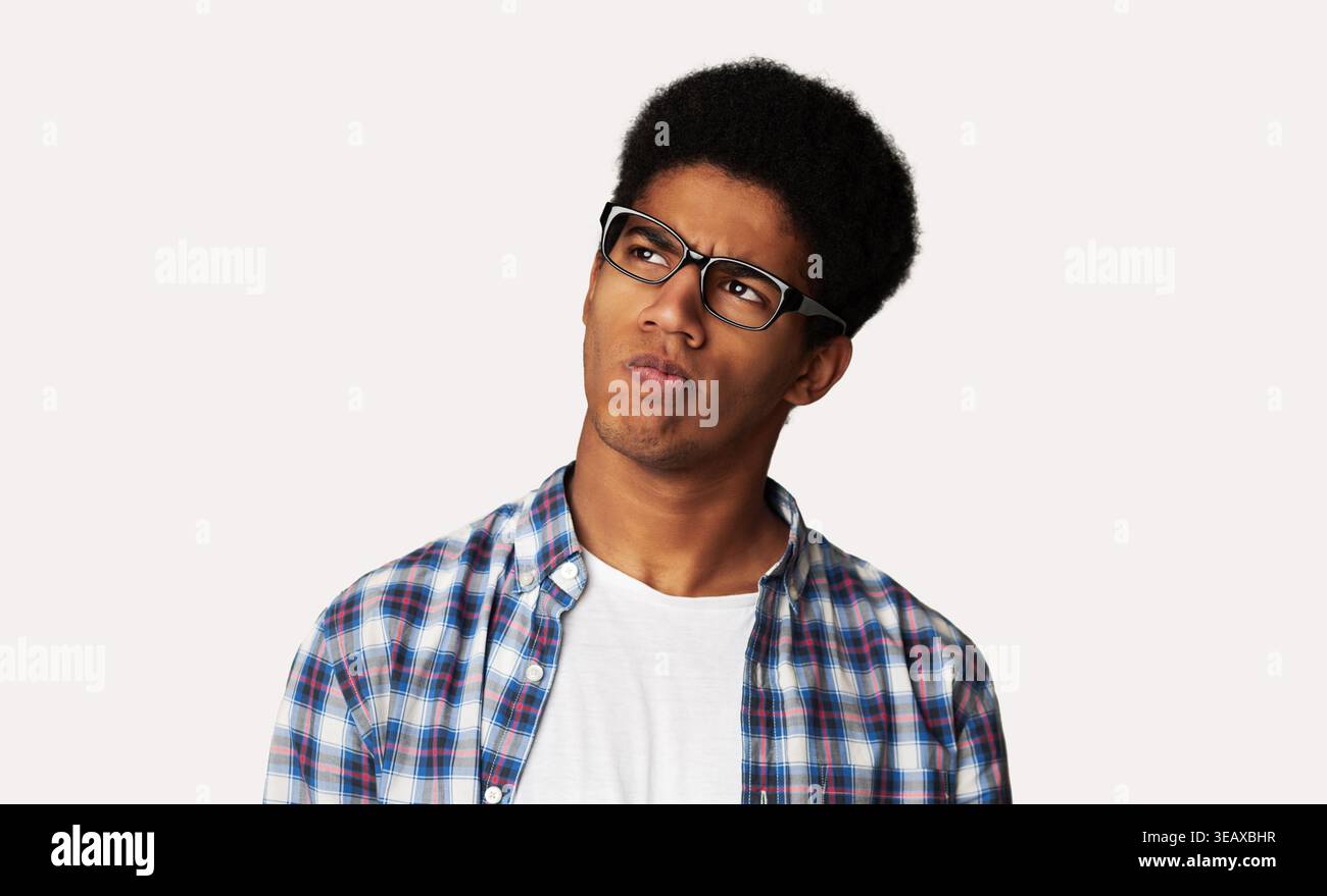 Thoughtful Afro Guy Thinking and Looking Aside Stock Photo