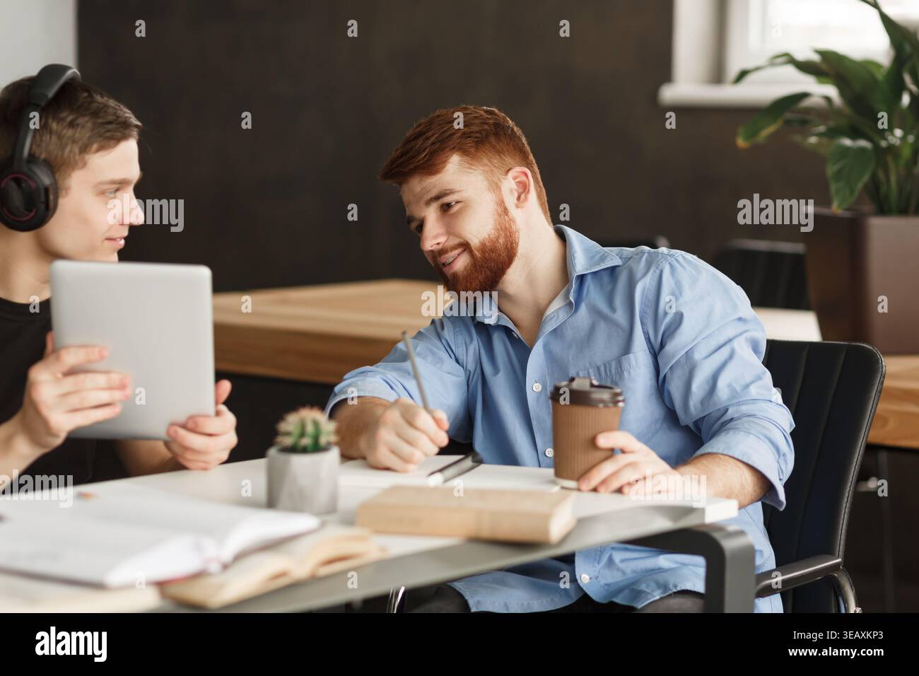 Smart student helping his classmate with homework Stock Photo