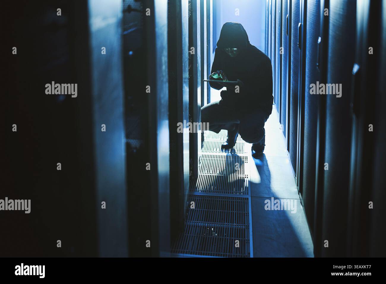 Hacker, coding and tablet in data center at night for malware, cyberattack and ransomware. Suspicious, person and digital with code script for hacking Stock Photo