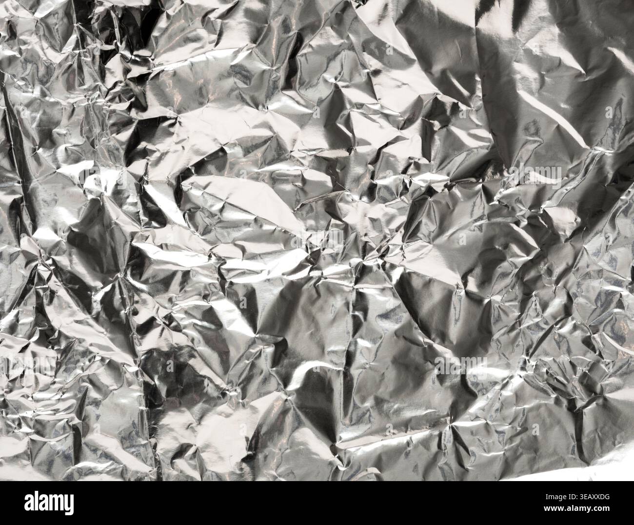 Collage of Crumpled Silver Foil Creating a Textured Background for Various Projects and Displays Stock Photo
