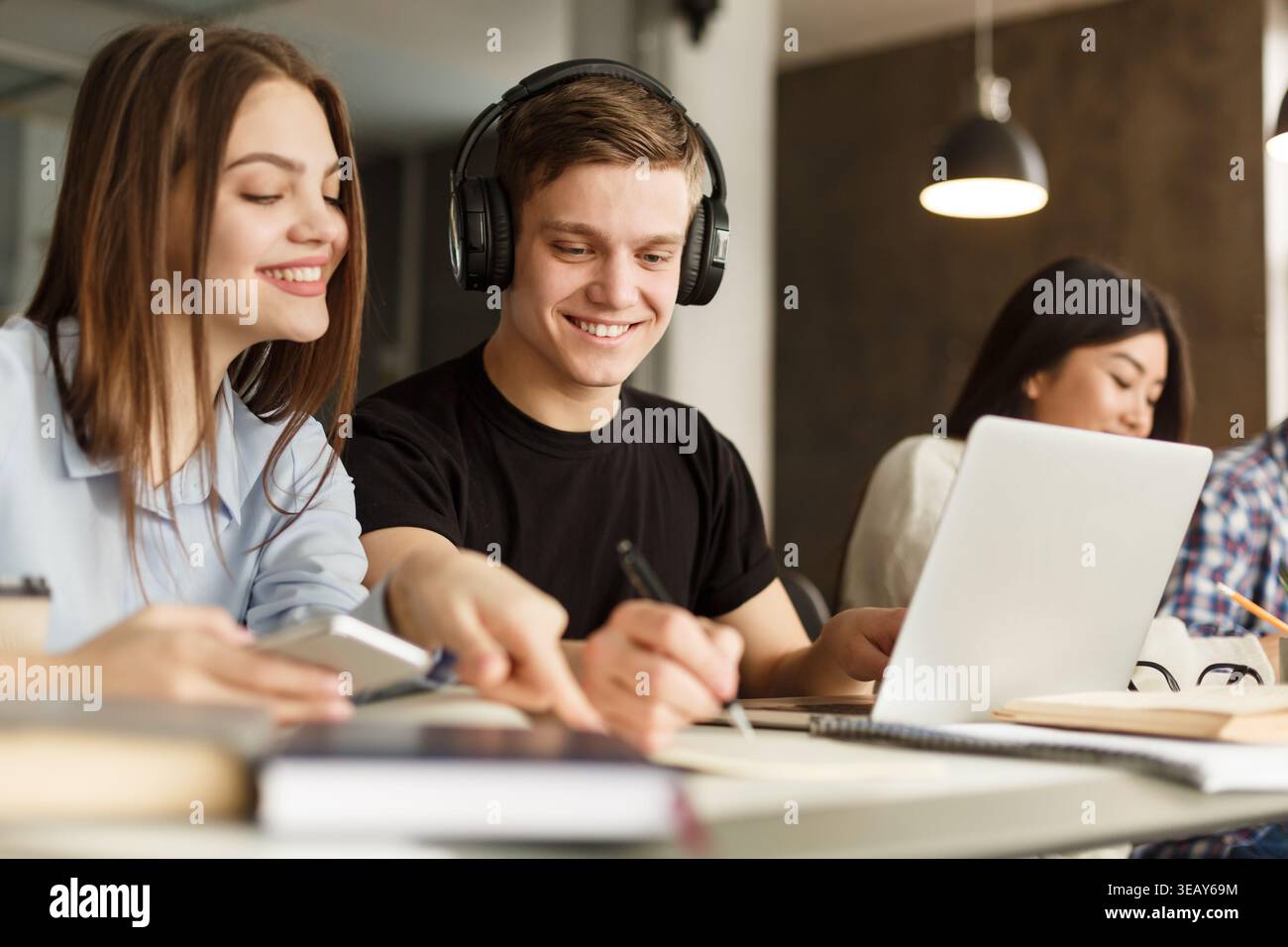 Students Collaborate on Projects in Modern Study Space During a Busy Afternoon Stock Photo
