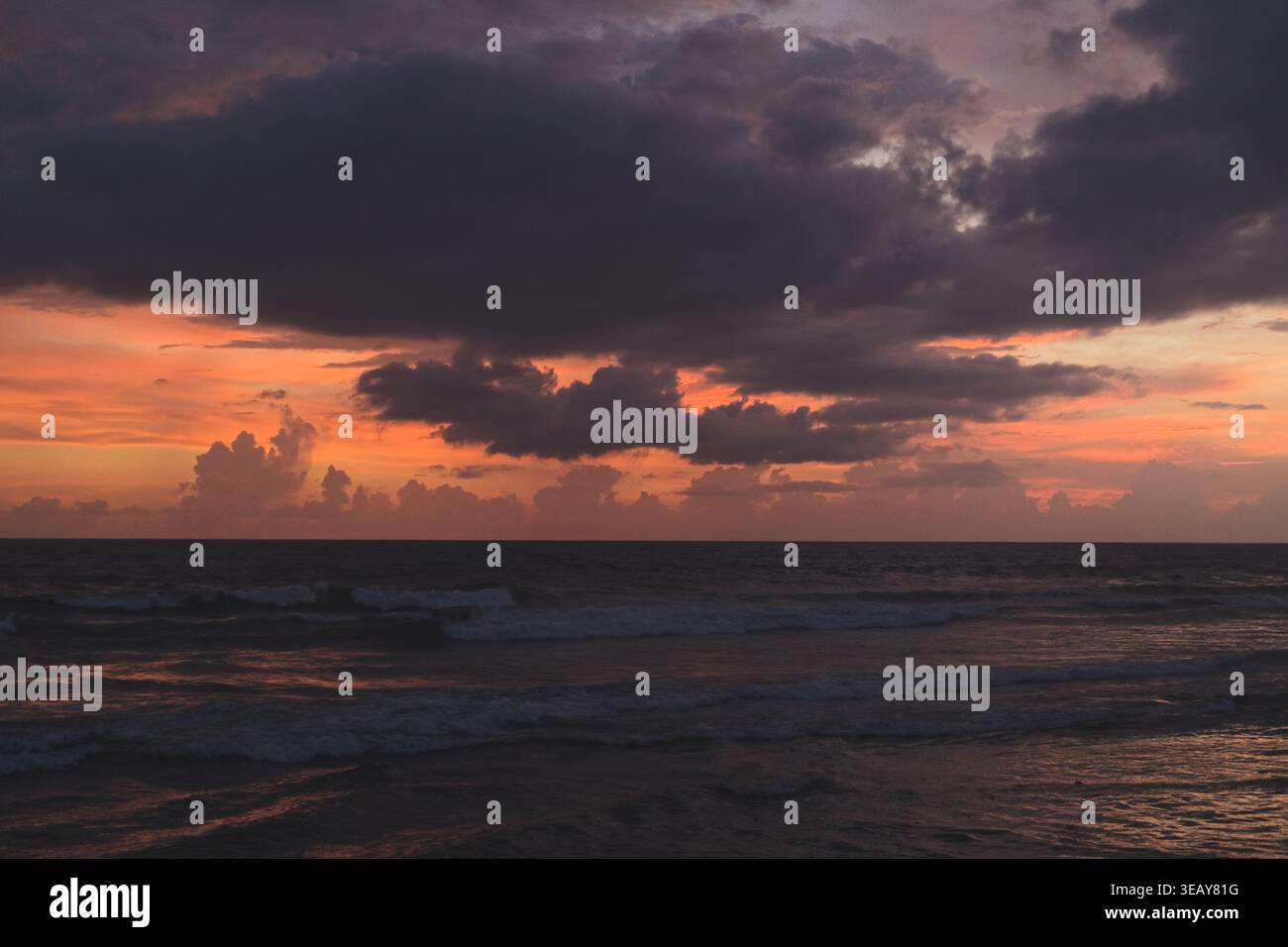 Dramatic stormy sunset sky over dark ocean waves, Bali Stock Photo - Alamy