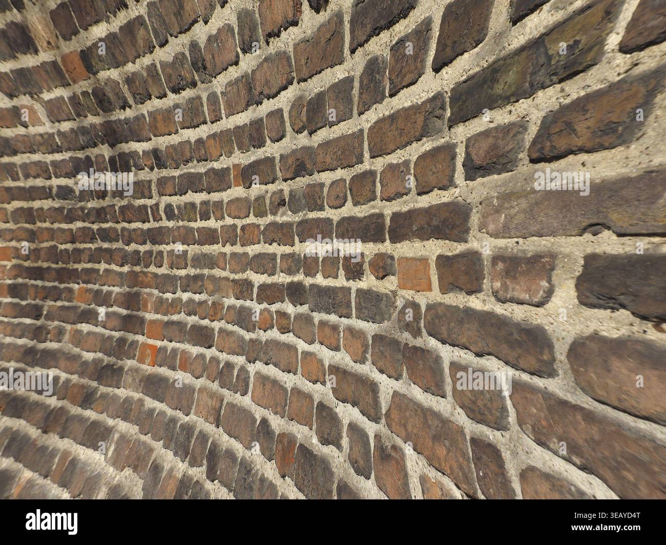 Curved red brick wall texture useful as a background Stock Photo