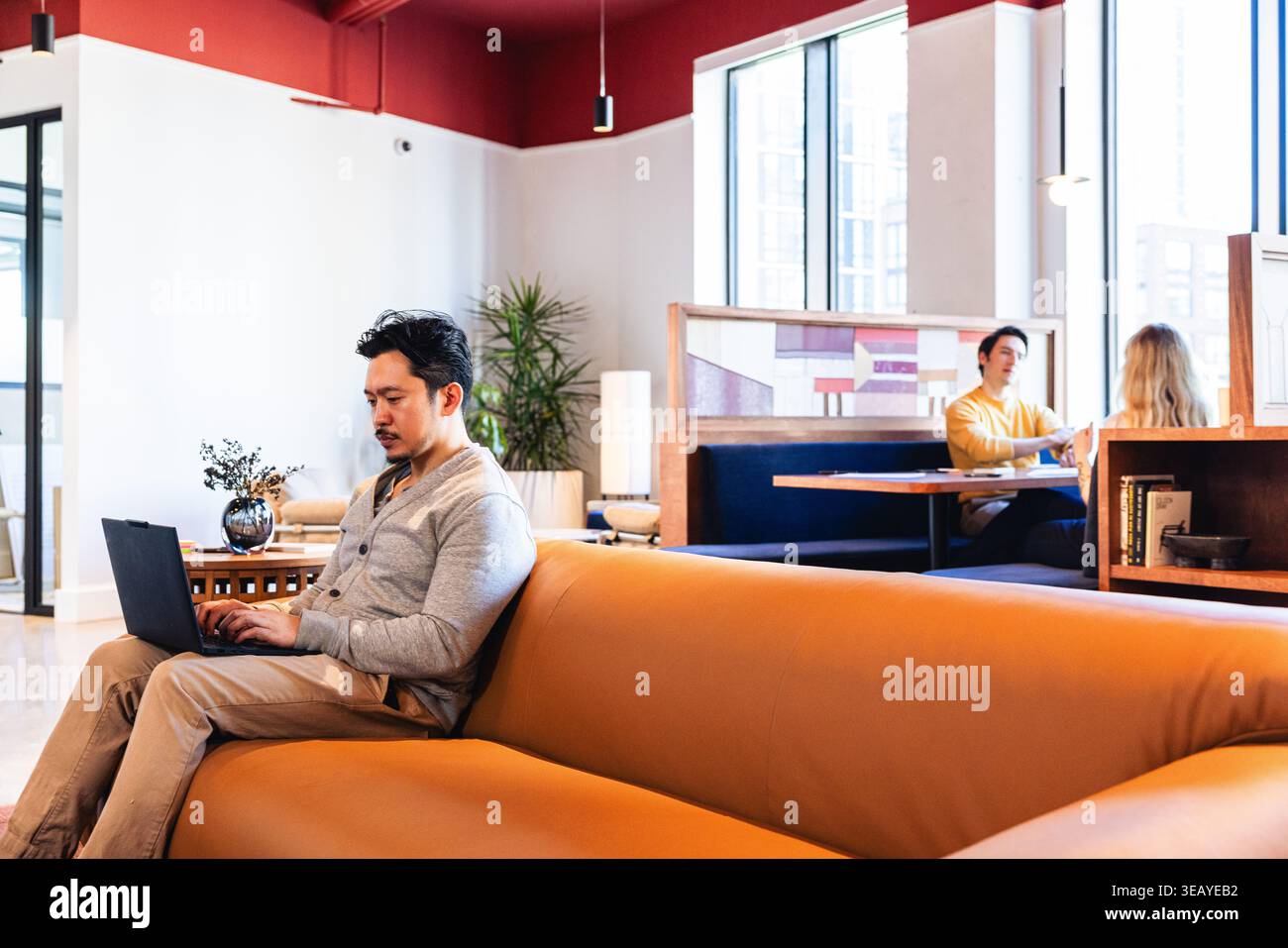 Young Asian Man Working in a collaborative Environment Stock Photo
