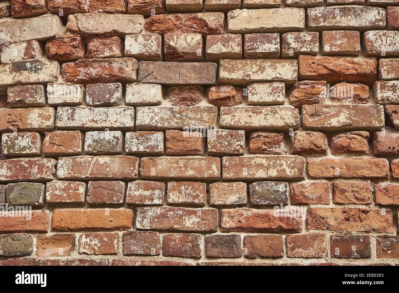 Old red brick wall background, uneven brickwork Stock Photo