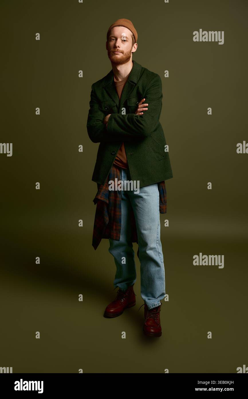 A handsome young man stands confidently, showcasing his stylish outfit ...