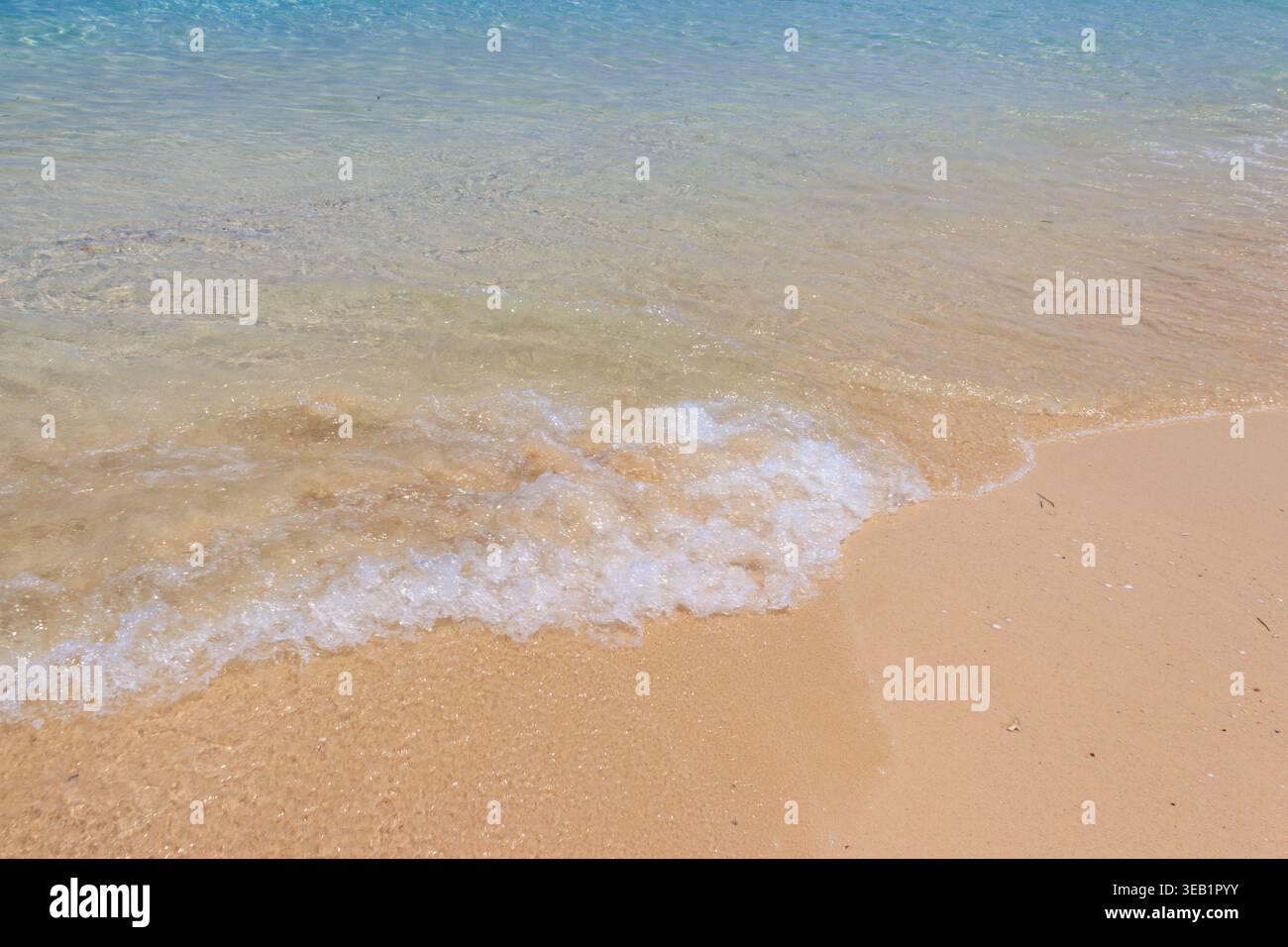 Soft wave of ocean on sandy beach Stock Photo