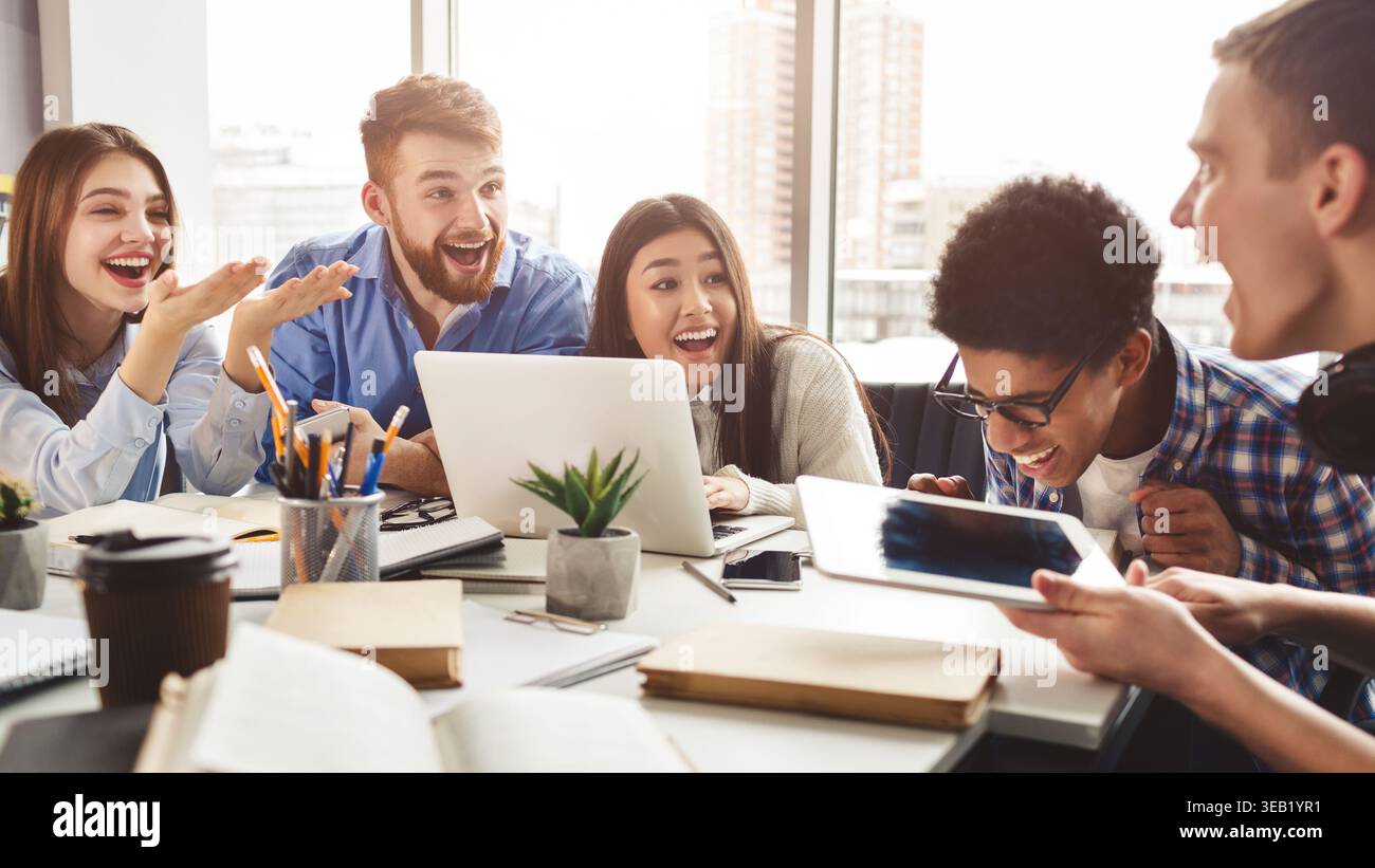 Multiethnic friends having fun, studying together for exams Stock Photo
