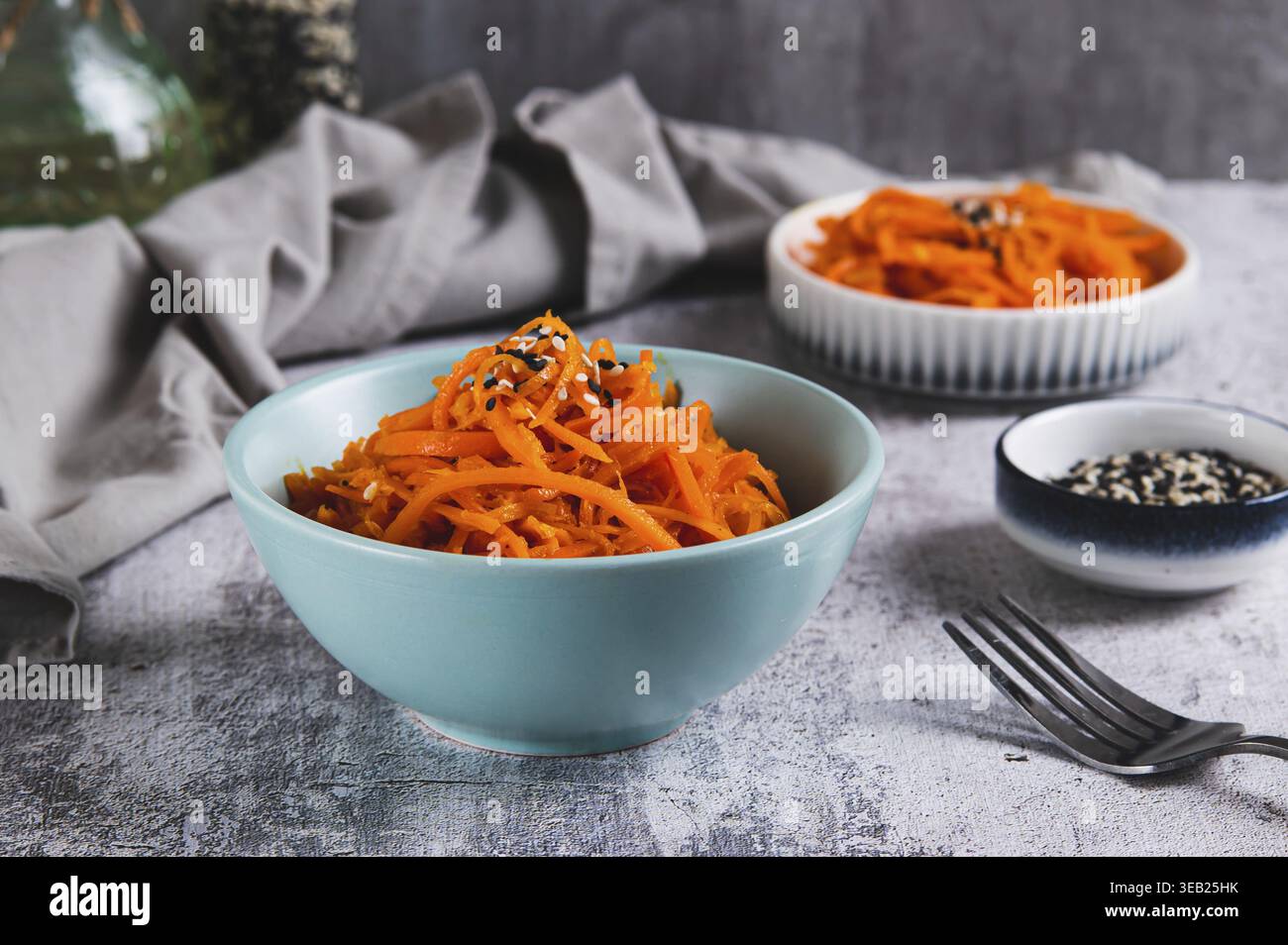 Korean carrots with sesame seeds in a bowl on the table Stock Photo