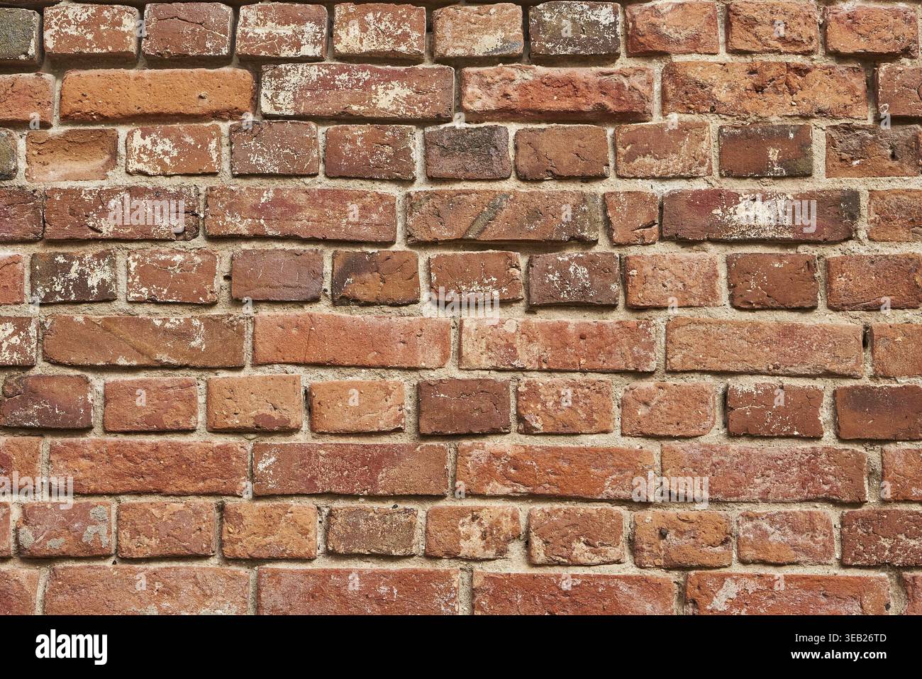 Old red brick wall background, uneven brickwork Stock Photo