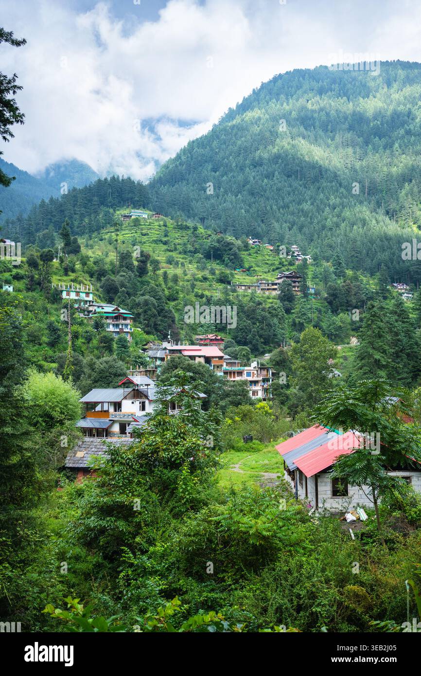 A picturesque mountain village surrounded by lush greenery and