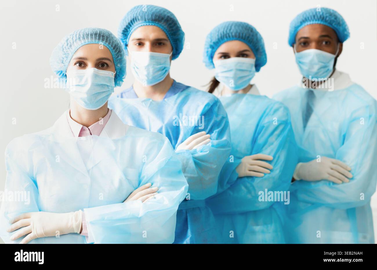 Surgeons Team Wearing Protective Uniforms, Standing In Row Stock Photo