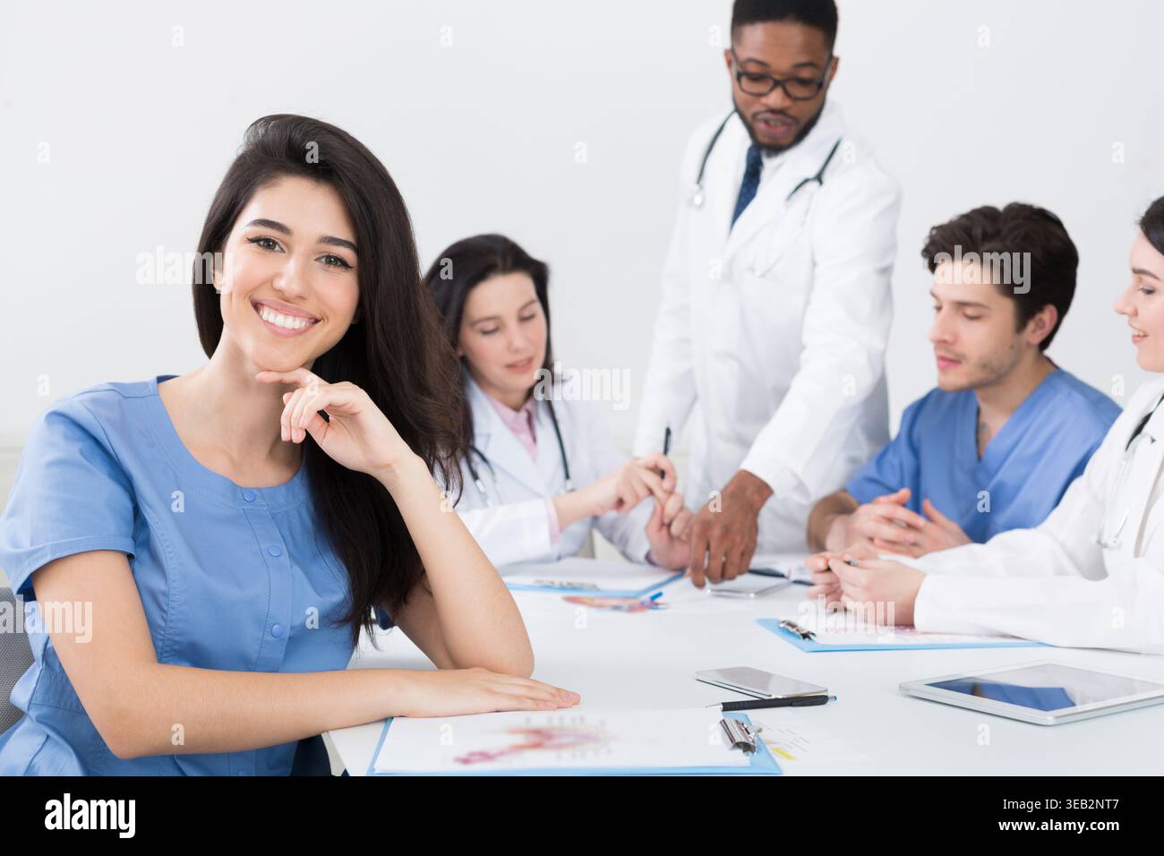 Young Intern Looking At Camera At Conference Stock Photo