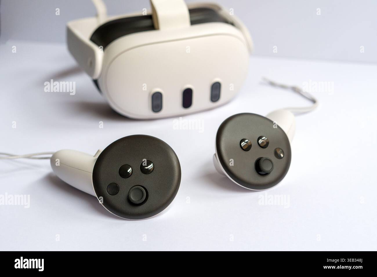 Modern virtual reality headset with wireless controllers on white background, VR technology concept, gaming and immersive experience device Stock Photo