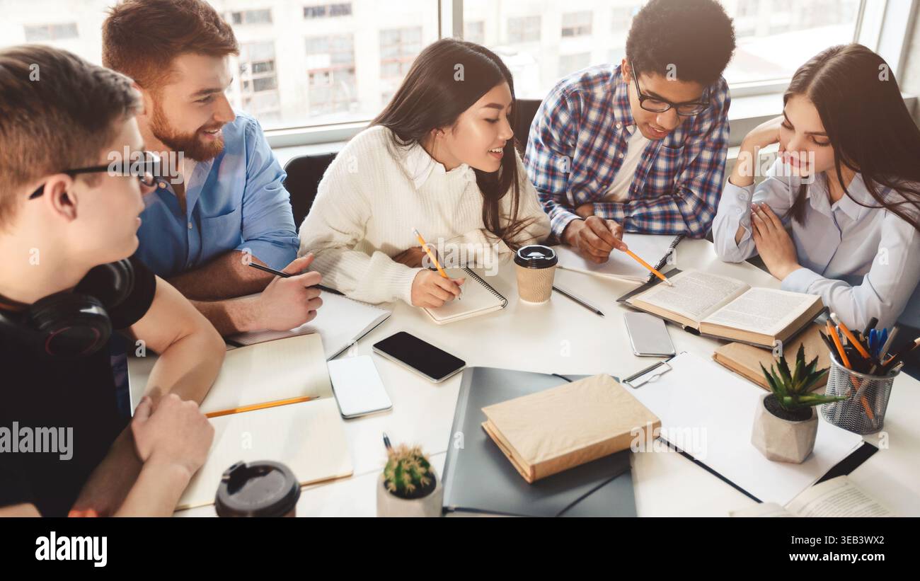 Students reading reference books for study notes Stock Photo