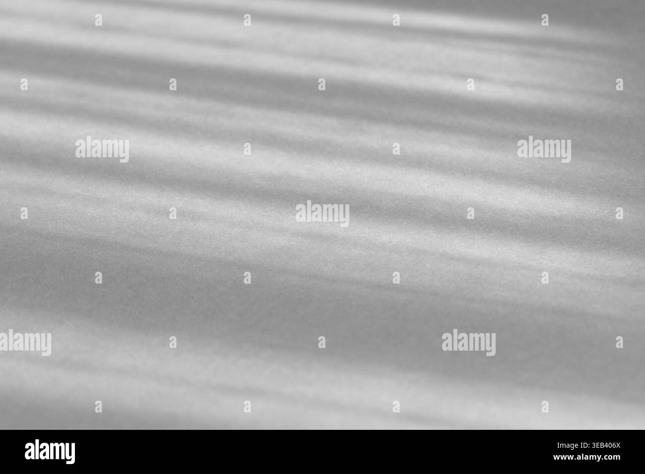 Abstract gray background showing sunbeams casting diagonal shadows and light stripes Stock Photo