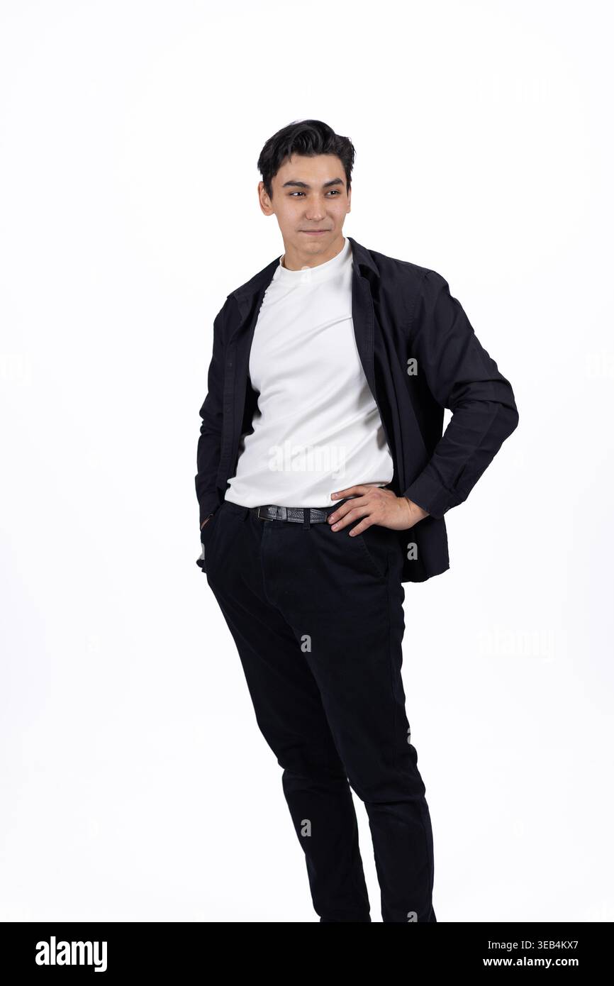Young man standing and posing with hands in pockets Stock Photo